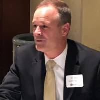 An alumnus talking at the Cover Letter and Resume Roundtable Event